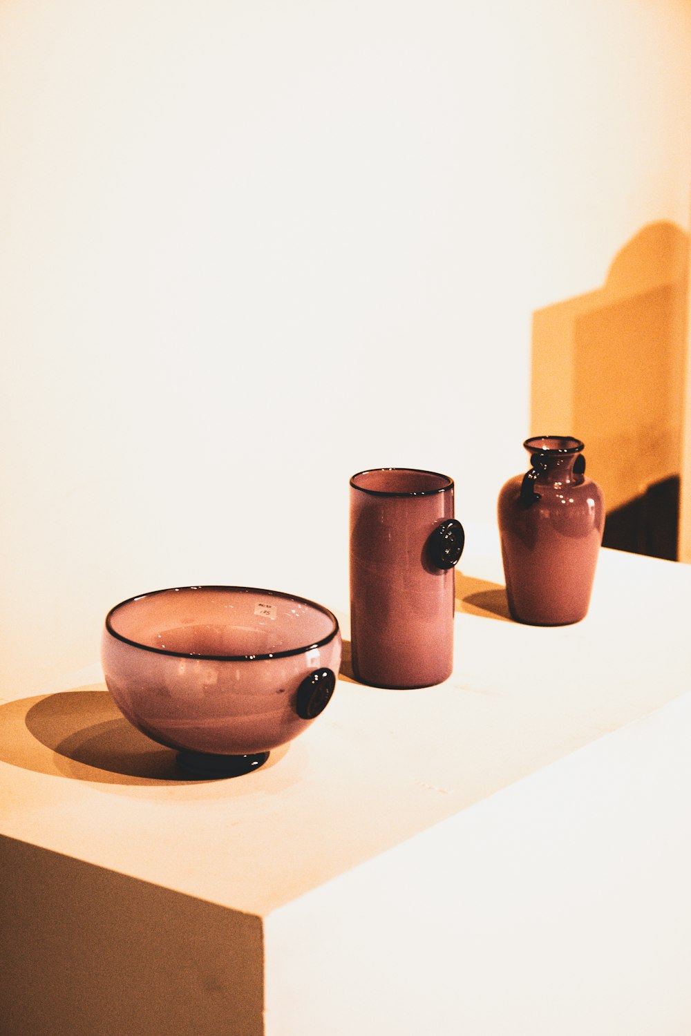 brown ceramic mug beside brown ceramic jar