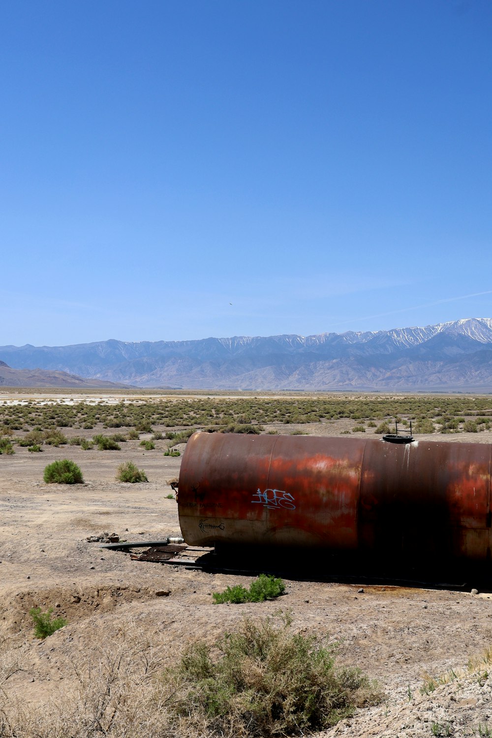 brown metal tank on brown field during daytime