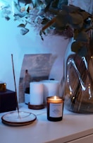 white pillar candle on glass holder