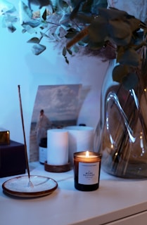 white pillar candle on glass holder