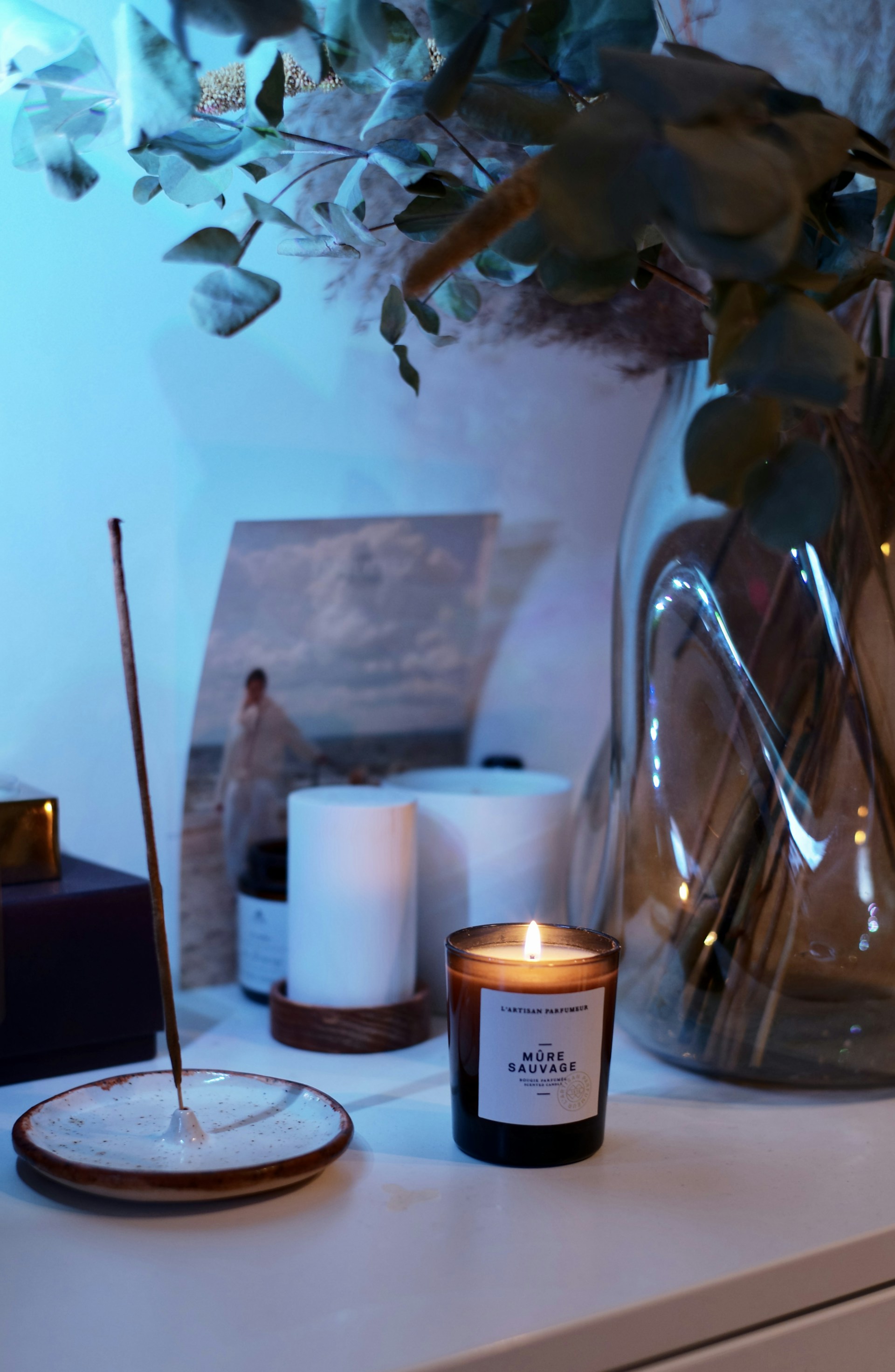 white pillar candle on glass holder