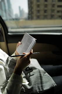 person in gray and black long sleeve shirt reading book
