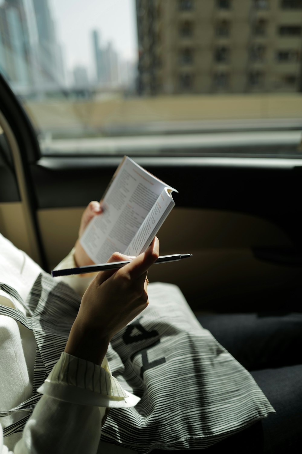 person in gray and black long sleeve shirt reading book