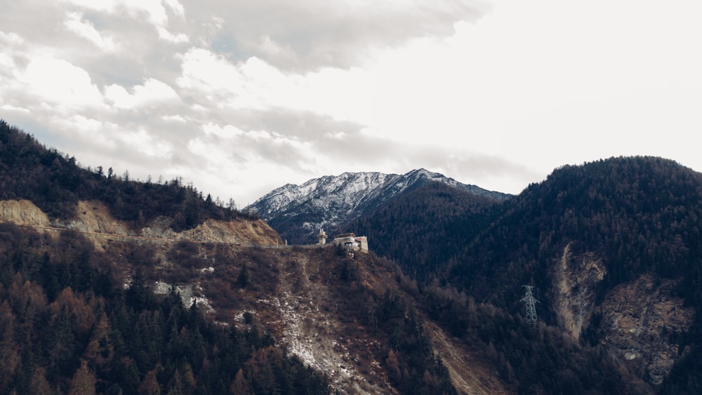 brown and green mountains under white clouds during daytime