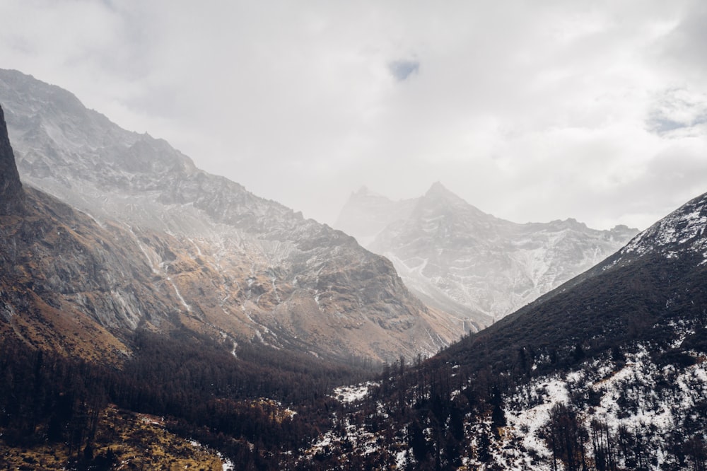 snow covered mountain under cloudy sky during daytime