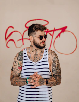 man in white and brown striped tank top wearing sunglasses