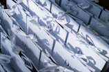 Elegant gift bags with delicate patterns and sturdy handles arranged on a wooden table.