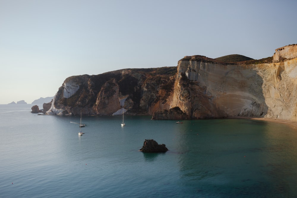 brown rock formation on sea during daytime