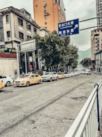 A busy urban street with multiple ride-share cars waiting for passengers.
