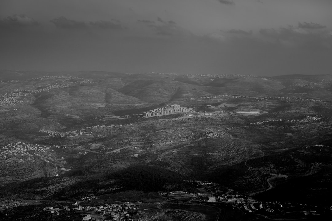 grayscale photo of mountains and clouds