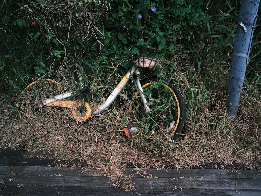 black and orange bicycle on brown wooden floor