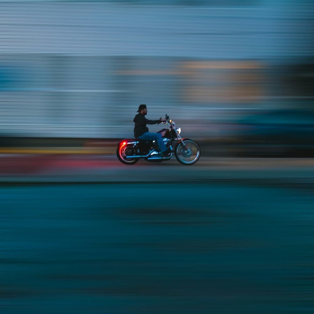 man riding motorcycle on road