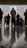 A group of people are standing in a room, viewed from a low angle that emphasizes the reflective flooring. The individuals appear engaged in an activity, possibly a prayer or meditation session, based on their posture. The room is softly lit, adding a serene atmosphere.