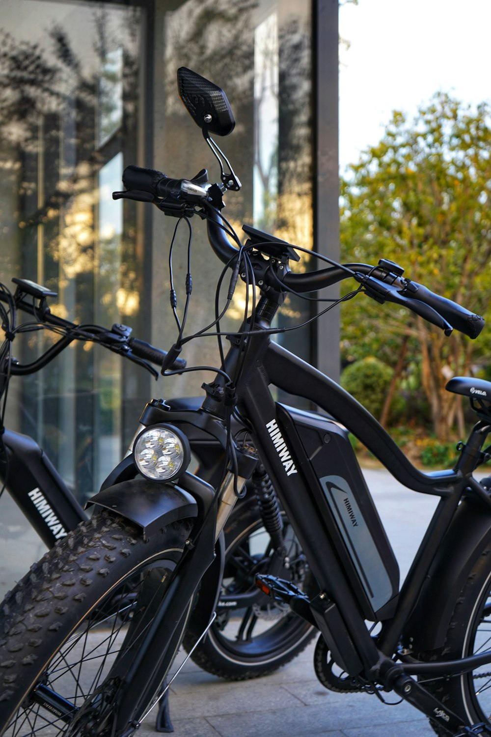 black and gray motorcycle parked beside brown wall