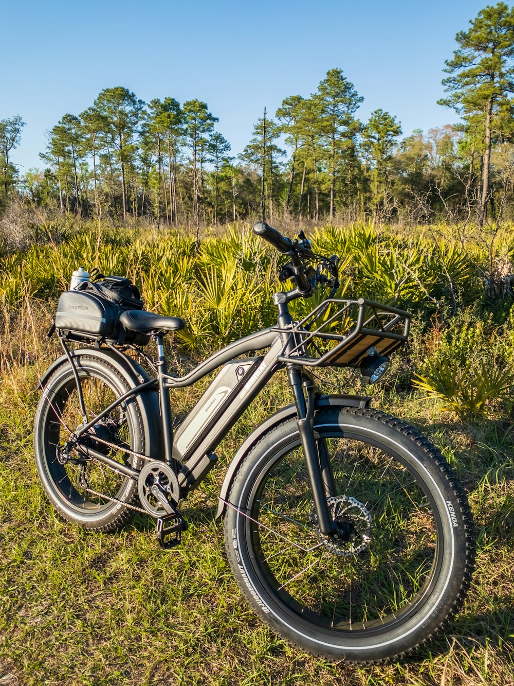 black and white mountain bike on green grass field during daytime