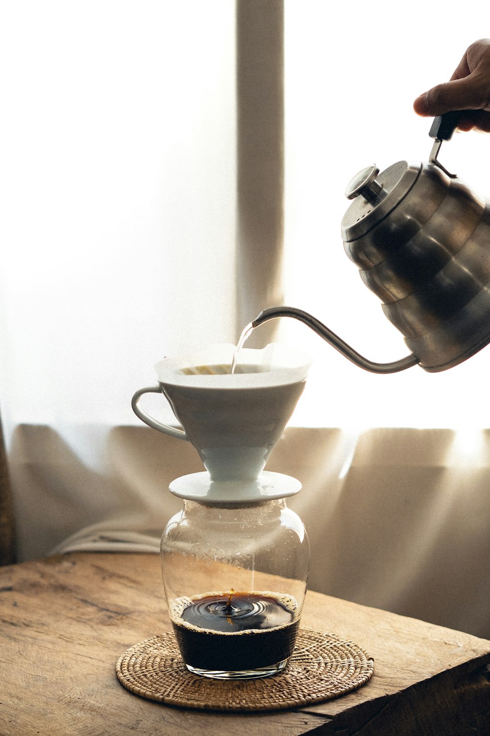 white ceramic teacup on clear glass saucer