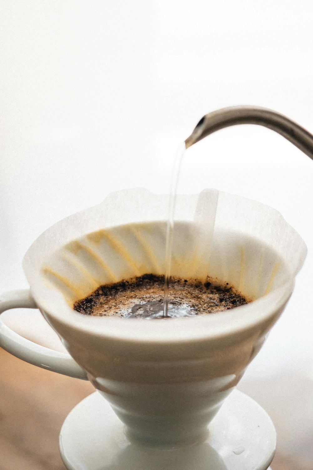 white ceramic cup with brown liquid