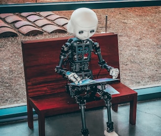 black and white robot toy on red wooden table