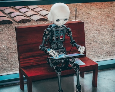 ai black and white robot toy on red wooden table
