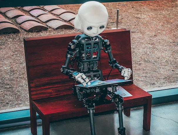 black and white robot toy on red wooden table