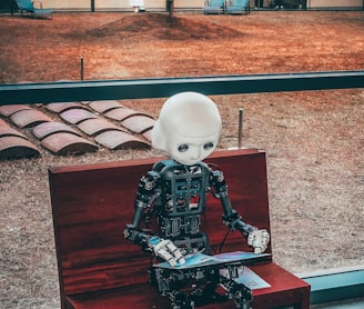 black and white robot toy on red wooden table