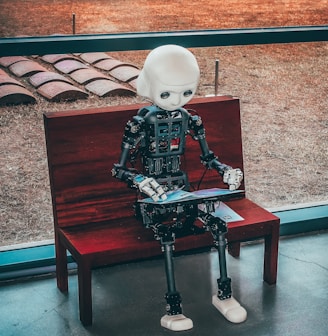 black and white robot toy on red wooden table