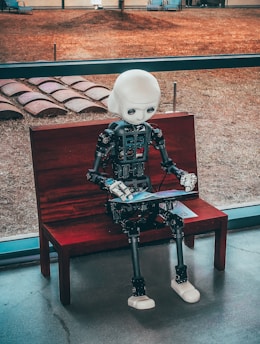 black and white robot toy on red wooden table