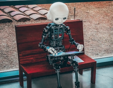 black and white robot toy on red wooden table