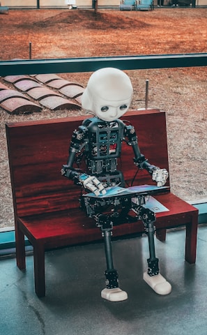 black and white robot toy on red wooden table