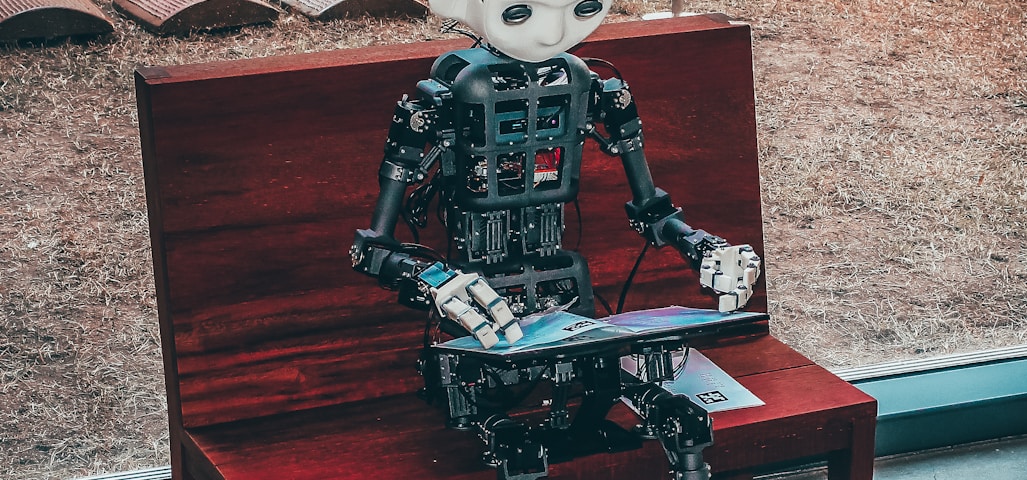 black and white robot toy on red wooden table