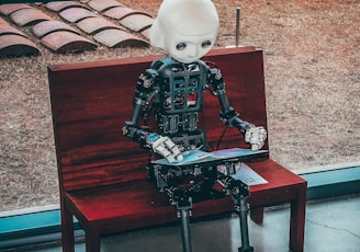 black and white robot toy on red wooden table