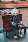 black and white robot toy on red wooden table