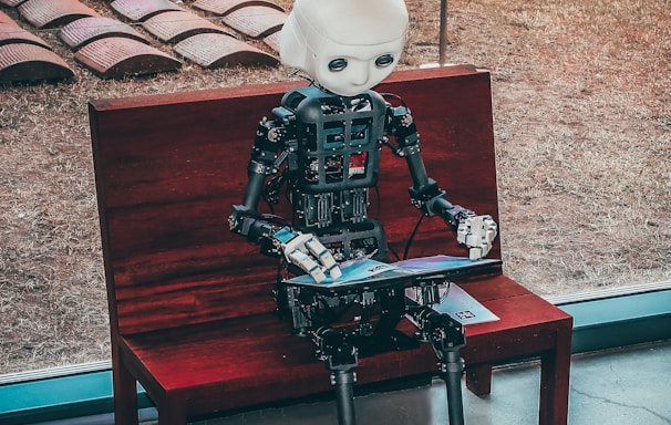 black and white robot toy on red wooden table