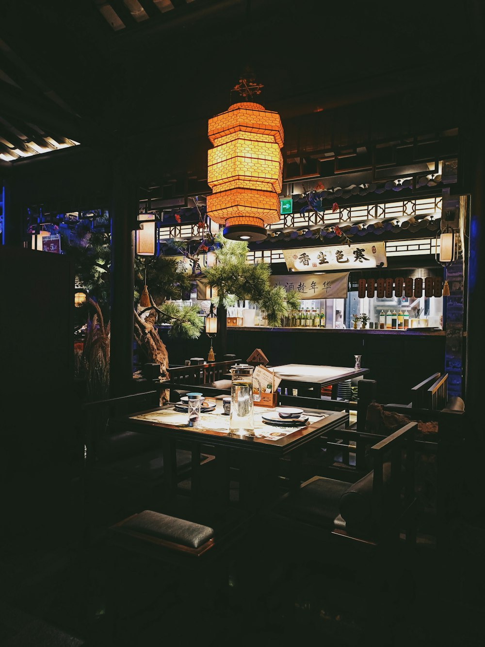 people standing near brown wooden table during night time