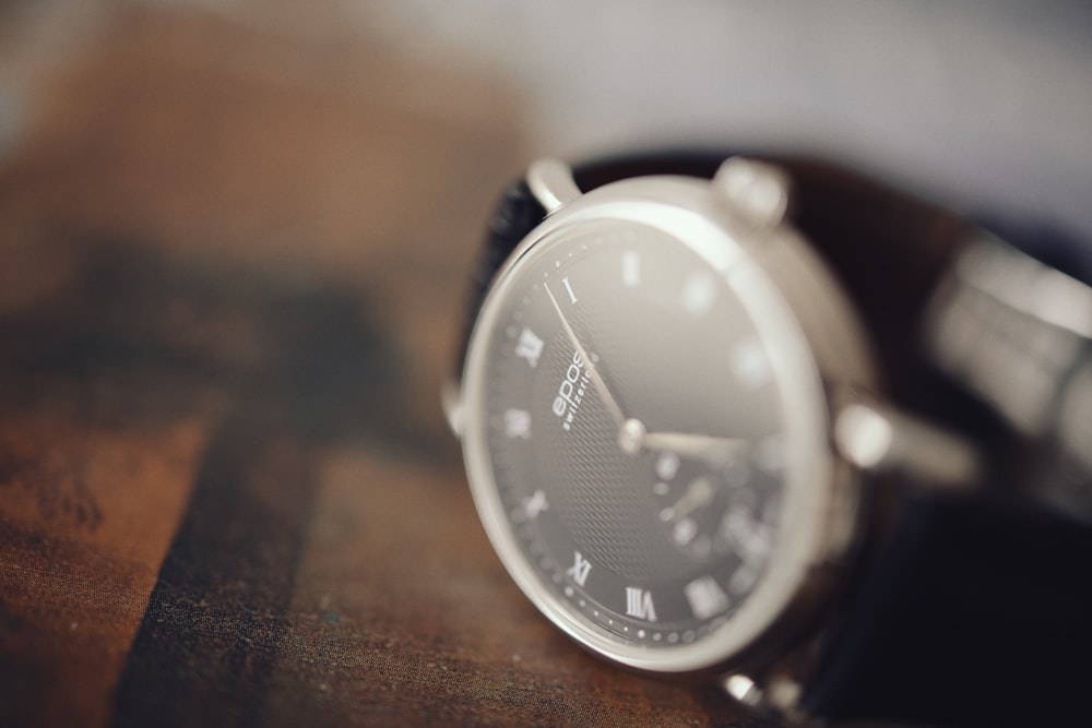 silver and black round analog watch