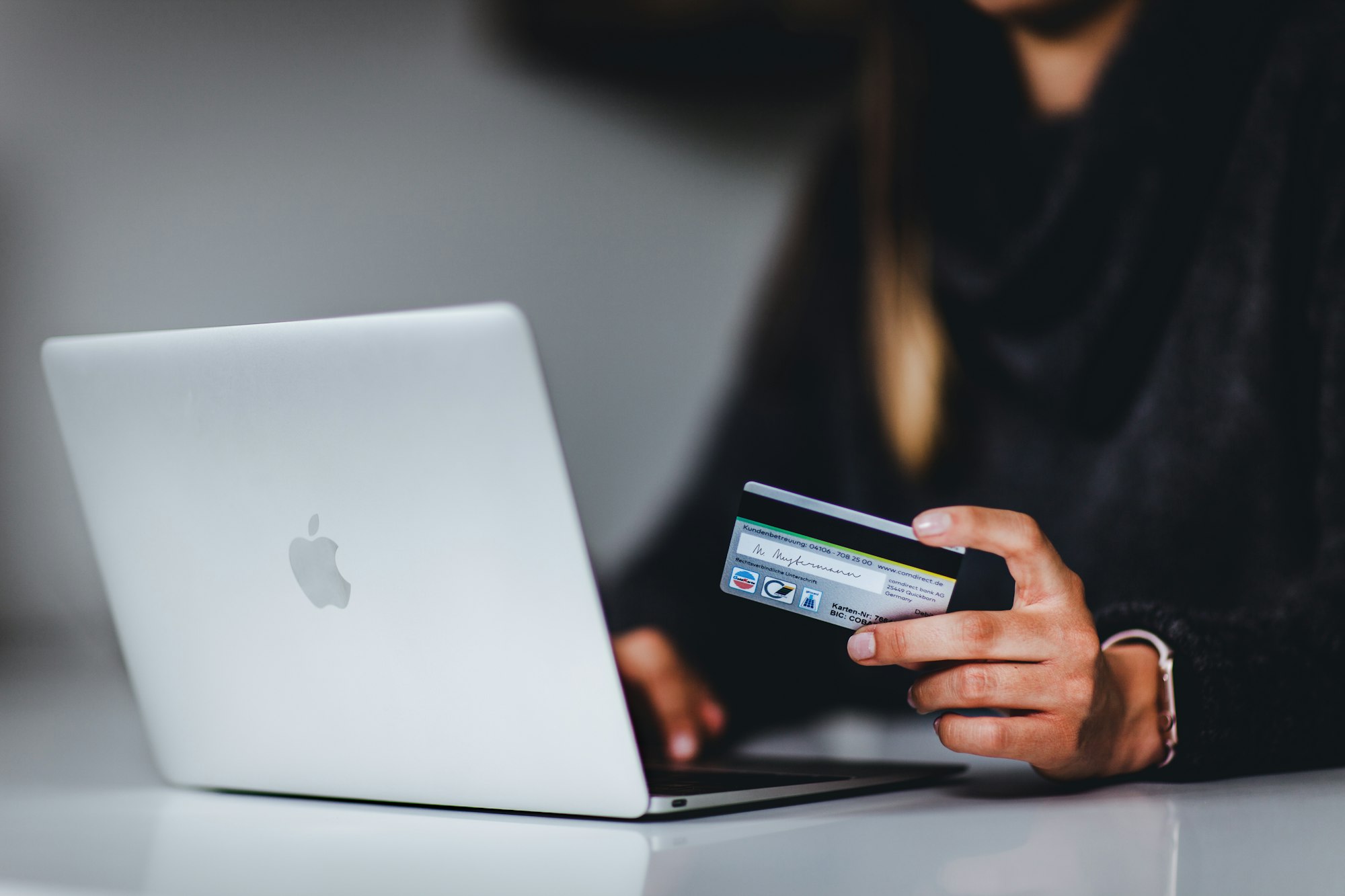 A woman who enters her bank details while shopping online.