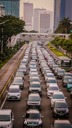 A busy Stockholm street filled with cars and pedestrians during the day.