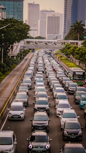 A busy Stockholm street filled with cars and pedestrians during the day.