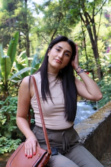 woman in gray tank top and gray shorts standing near green leaf tree during daytime
