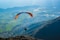 person in black shirt with yellow parachute over the mountains during daytime