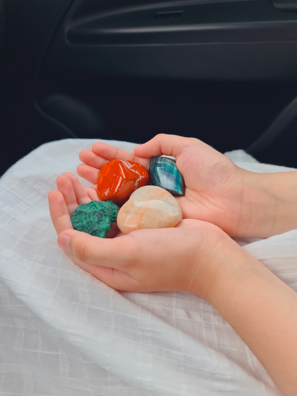 person holding green plastic toy