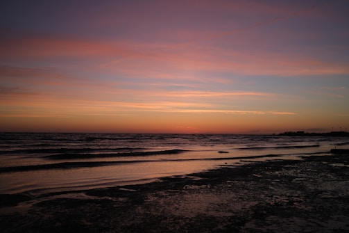 A serene sunset over a tranquil beach, reflecting Bobby's artistic vision.