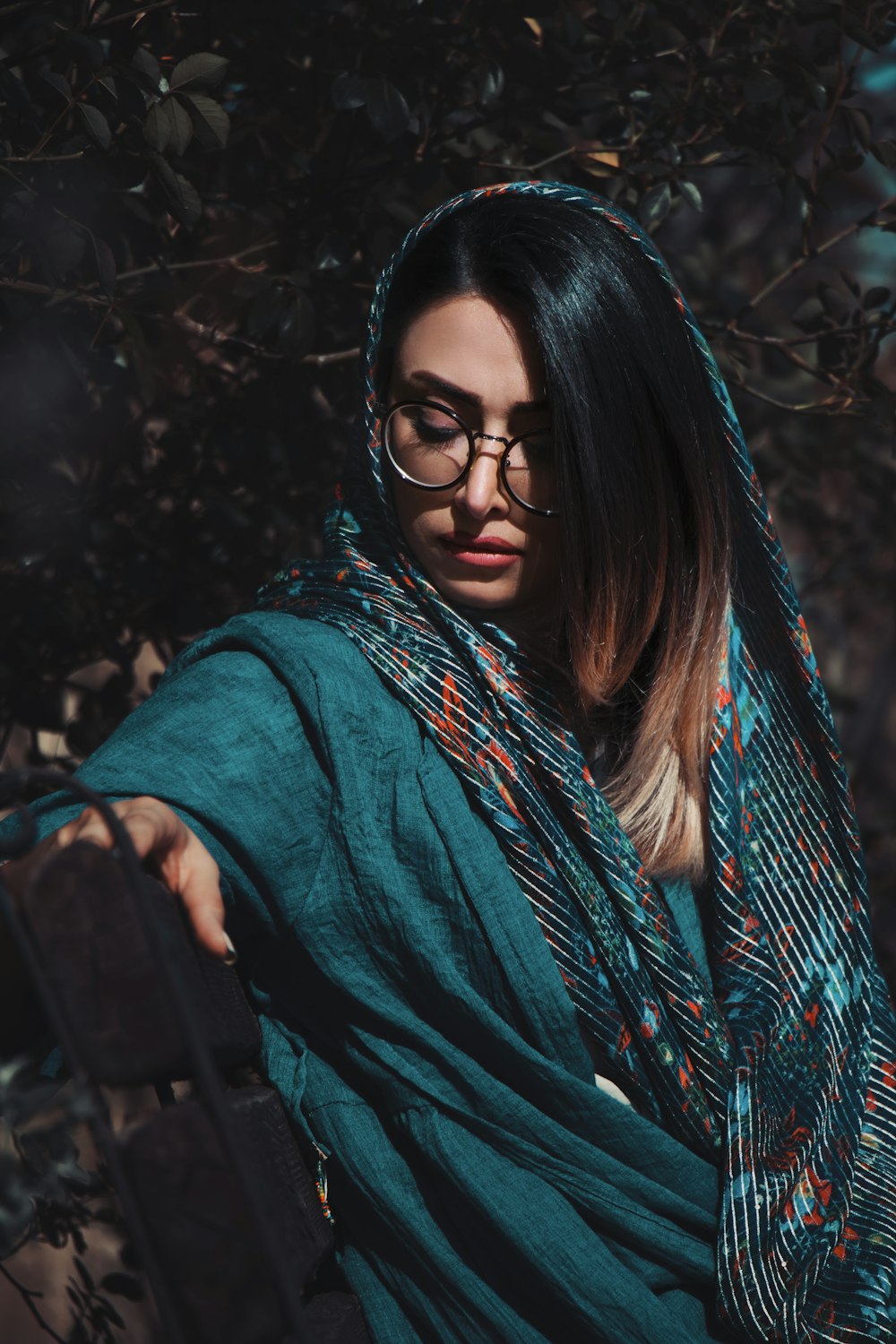 woman in green and black scarf and black framed eyeglasses