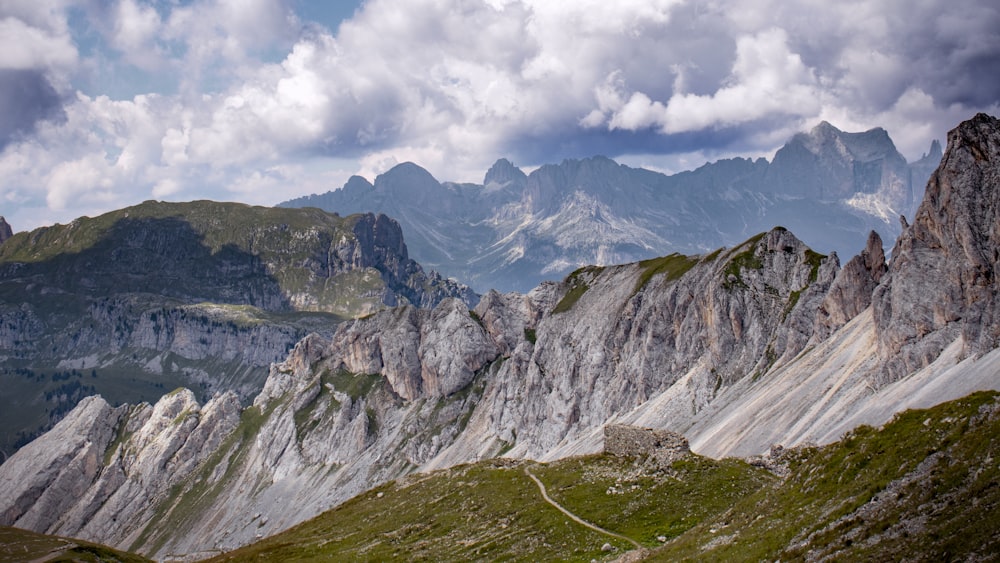 green and gray mountains under white clouds and blue sky during daytime