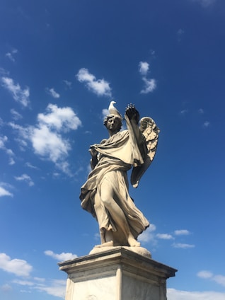 A majestic guardian angel with outstretched wings overlooking a misty British landscape, symbolizing protection and guidance.