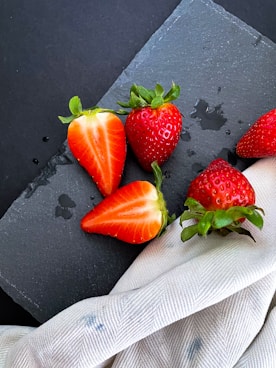 red strawberry on black surface