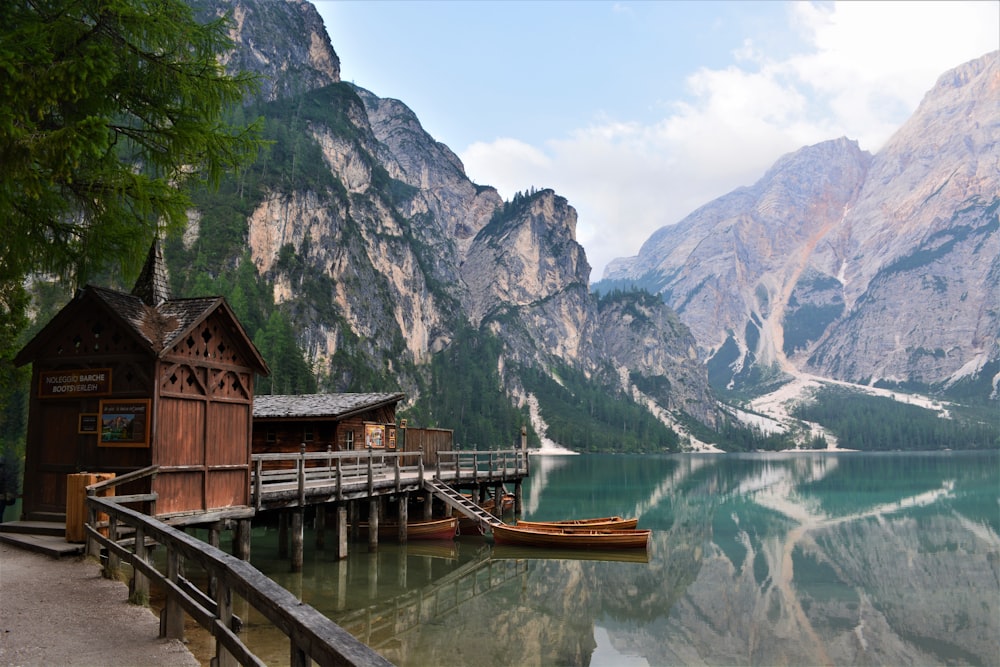 brown wooden boat on river near mountain during daytime