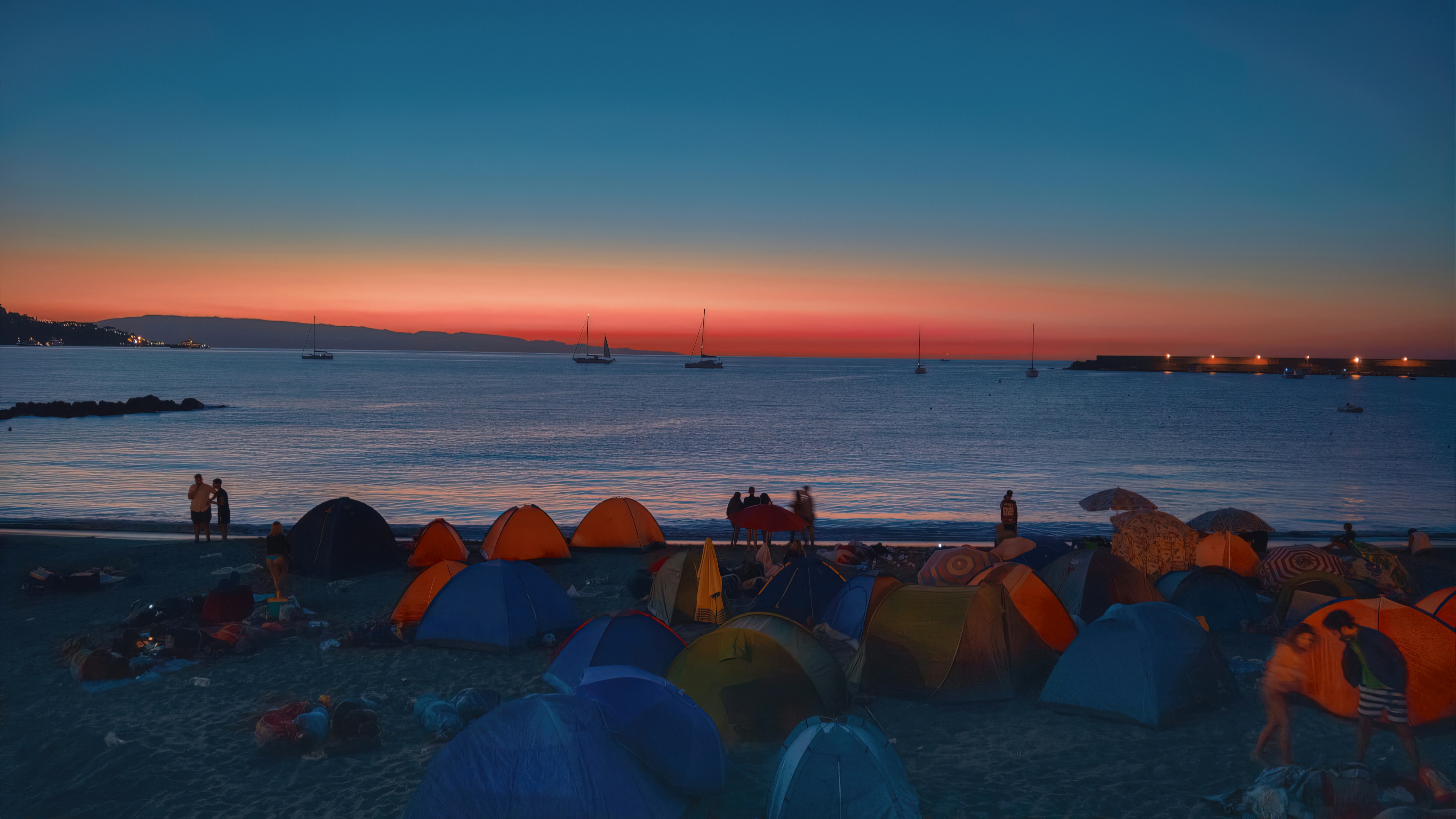 people on beach during sunset