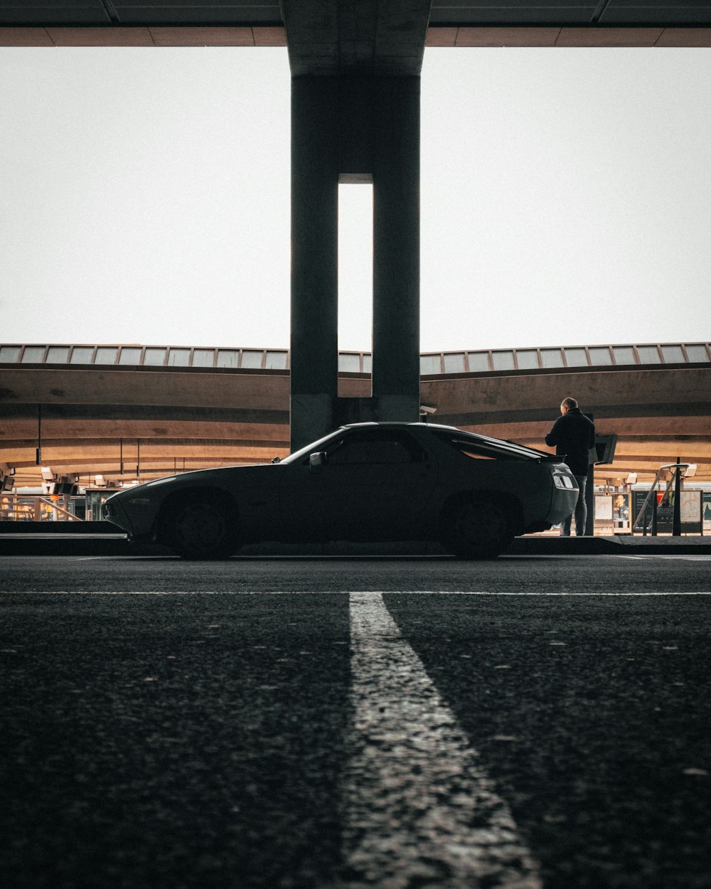 black porsche 911 parked on road during daytime