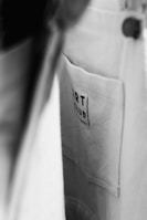 A close-up view of a fabric pocket with a label that reads 'ART CLUB'. The image is in black and white, with a focus on texture and contrast.